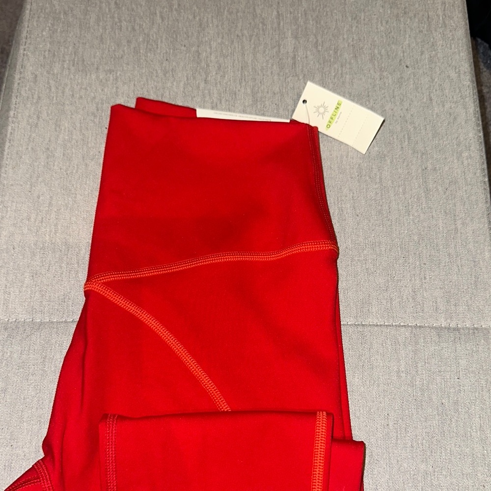 OFFLINE 7/8 legging. color is a burnt red/orange w/ a light orange stitching.